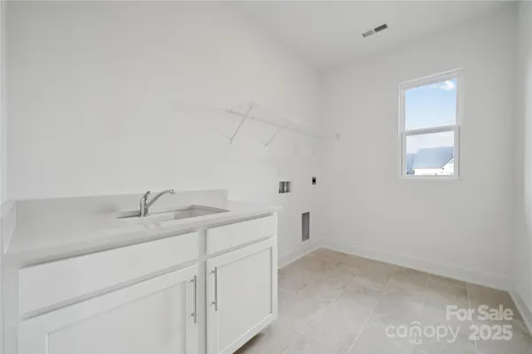 a utility room with cabinets washer and dryer