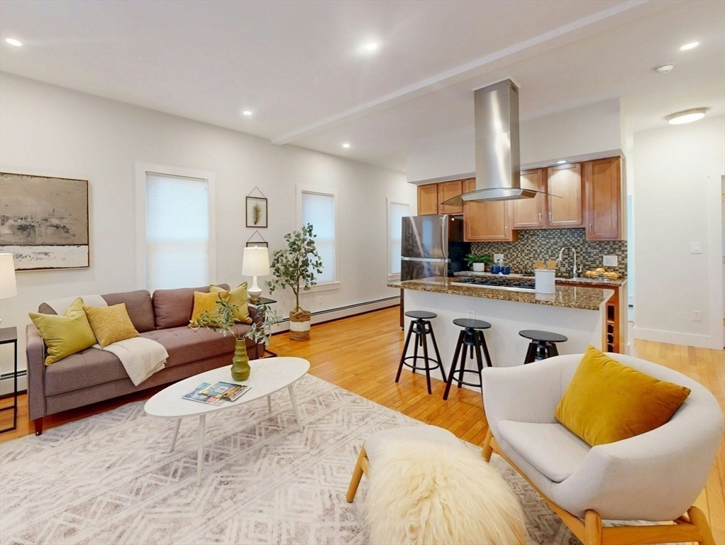 80 Newton Street, Unit 2 Somerville, MA 02143 - Photo 1 of 9 a living room with furniture and a table