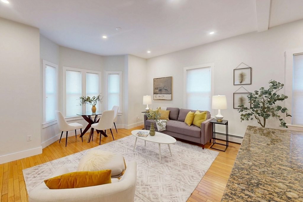 80 Newton Street, Unit 2 Somerville, MA 02143 - Photo 4 of 9 a living room with furniture and a wooden floor