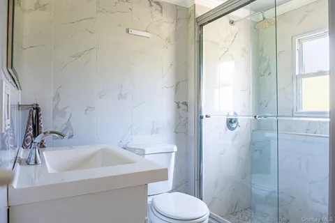 a bathroom with a sink toilet and shower