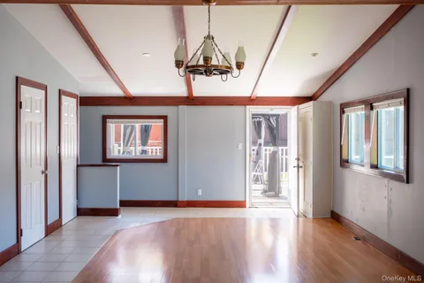 a view of a room with wooden floor and windows