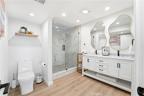a spacious bathroom with a granite countertop sink mirror and toilet