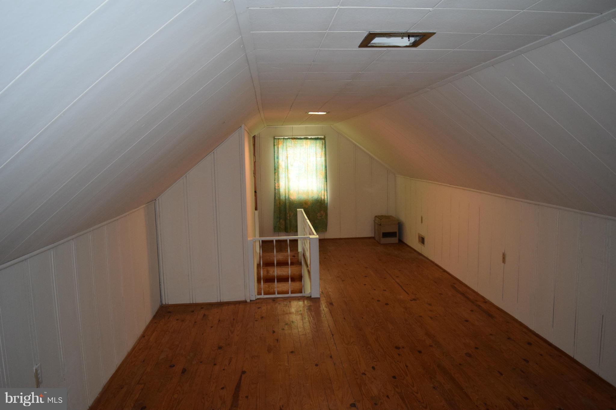 314 Worton Road Baltimore, MD 21221 - Photo 19 of 30 an empty room with wooden floor and windows