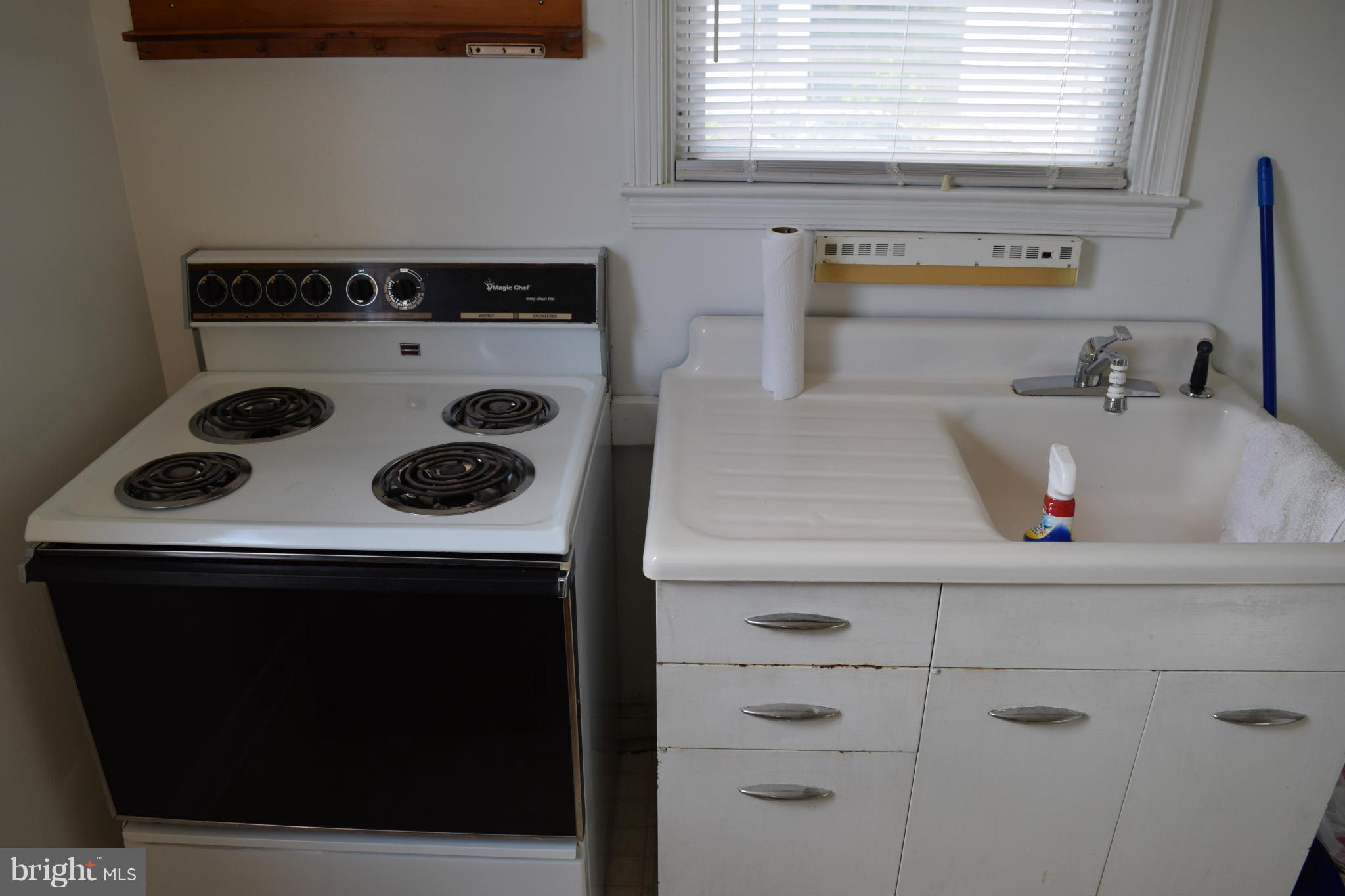 314 Worton Road Baltimore, MD 21221 - Photo 22 of 30 a kitchen with a stove and a microwave