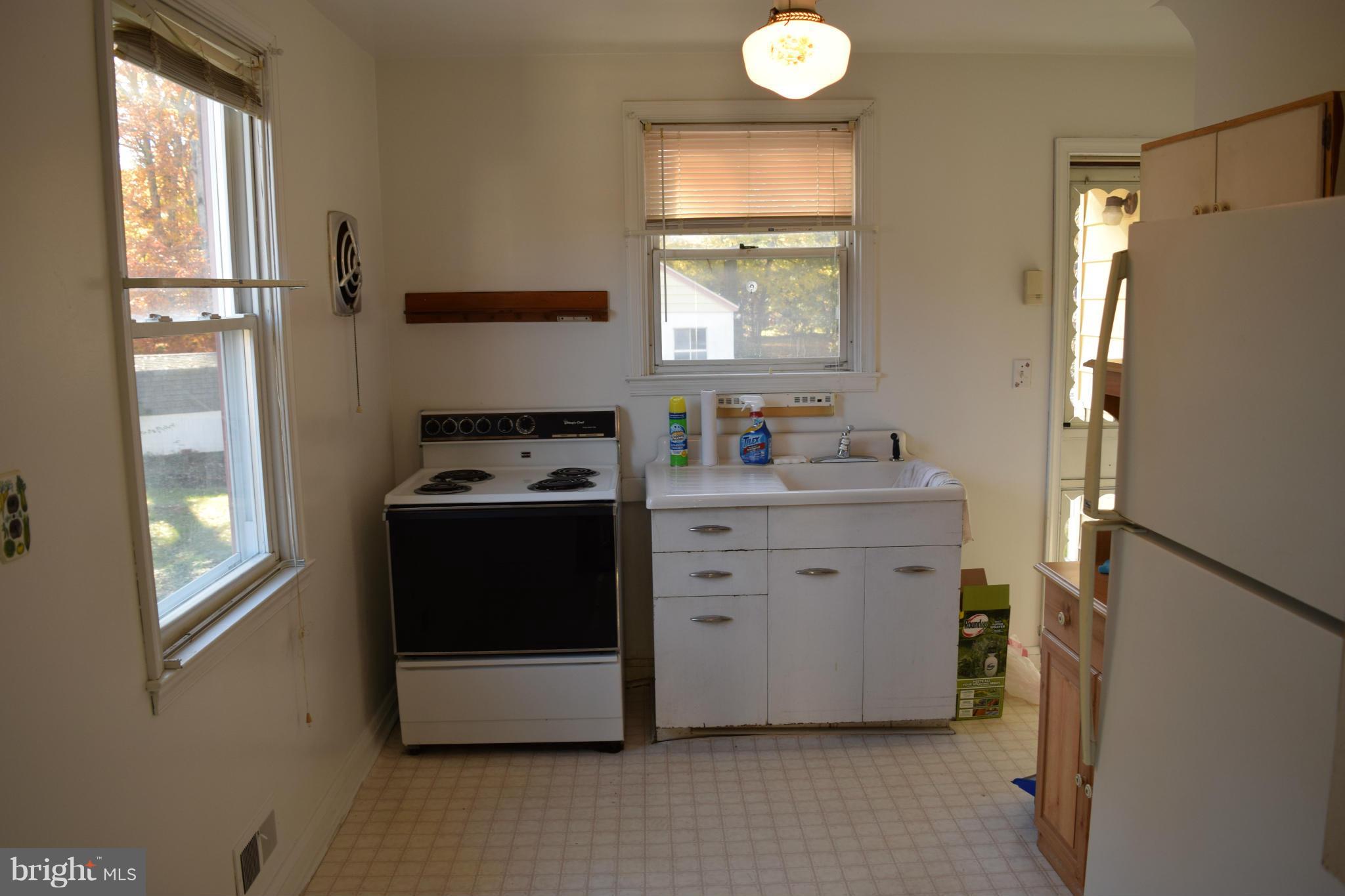 314 Worton Road Baltimore, MD 21221 - Photo 28 of 30 a kitchen with a refrigerator and window