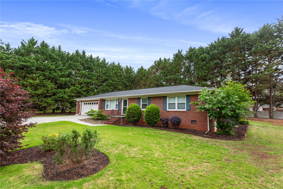202 Keowee Trail Seneca, SC 29672 - Photo 2 of 35 This classic brick residence features an attached garage and a neatly manicured lawn.