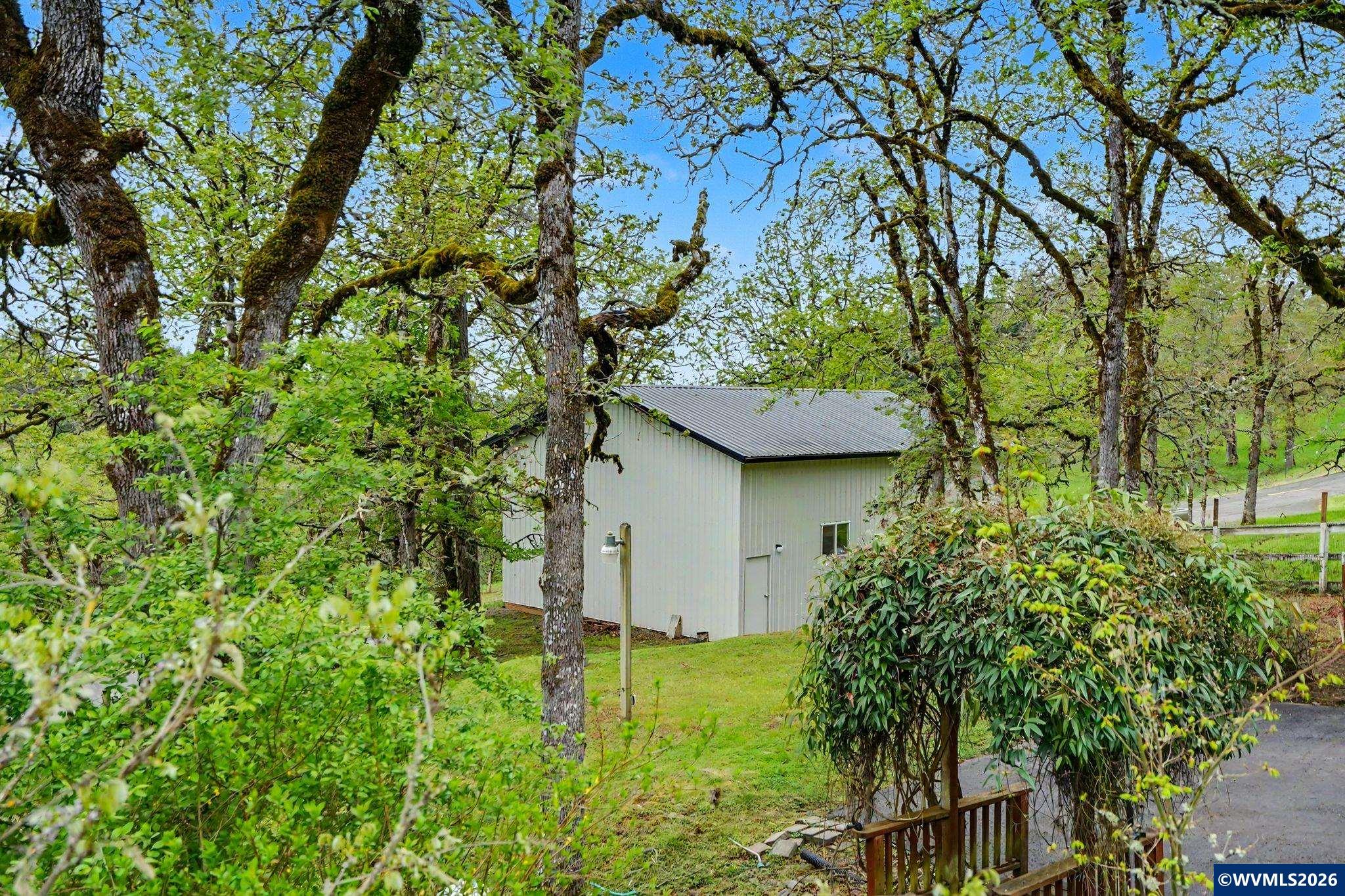 1299 Twin Hills Road Southeast Jefferson, OR 97352 - Photo 37 of 47 a backyard of a house with plants and large trees