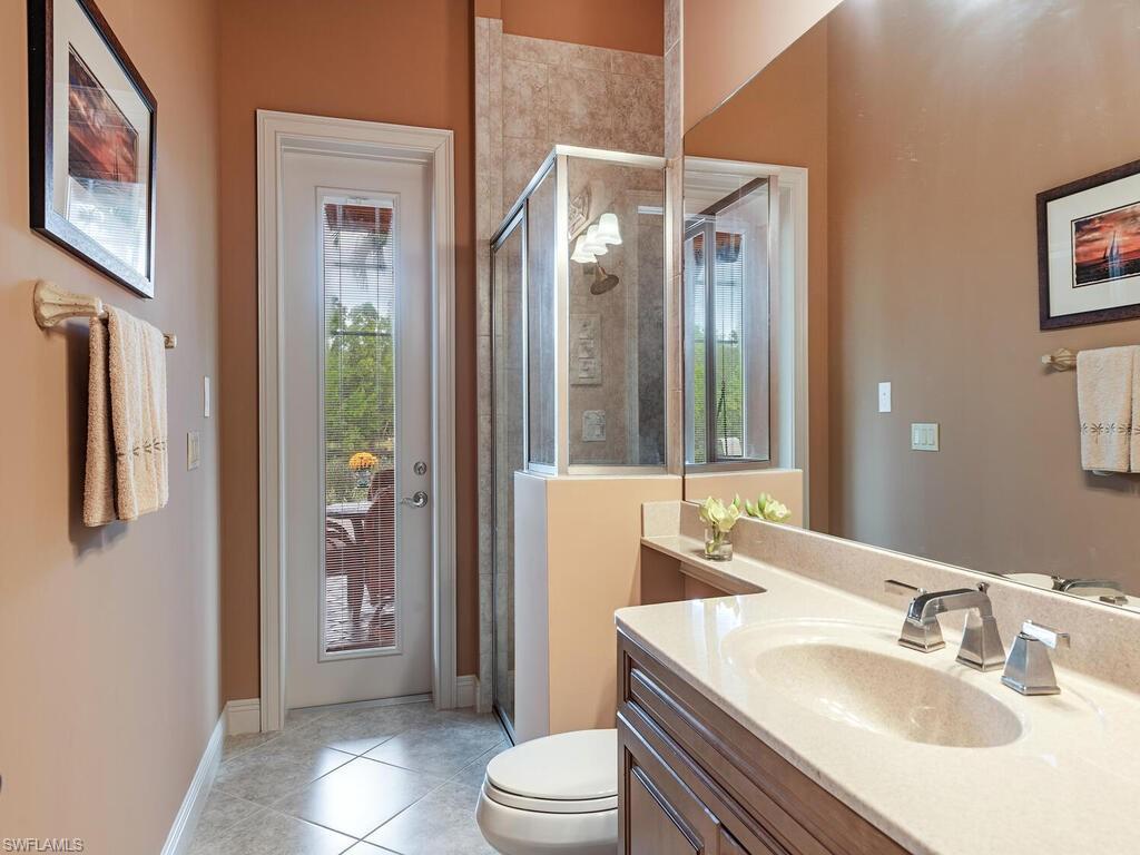 1749 Supreme Court Naples, FL 34110 - Photo 12 of 18 a bathroom with a sink a toilet and shower
