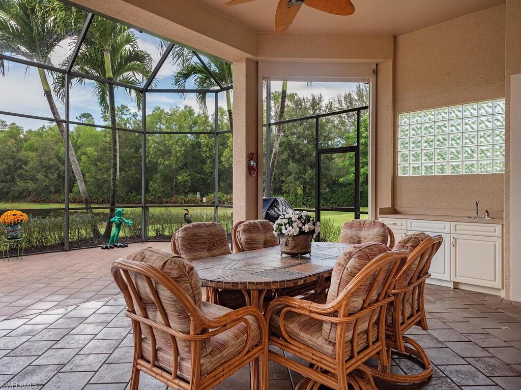 1749 Supreme Court Naples, FL 34110 - Photo 14 of 18 a view of a patio with a dining table and chairs