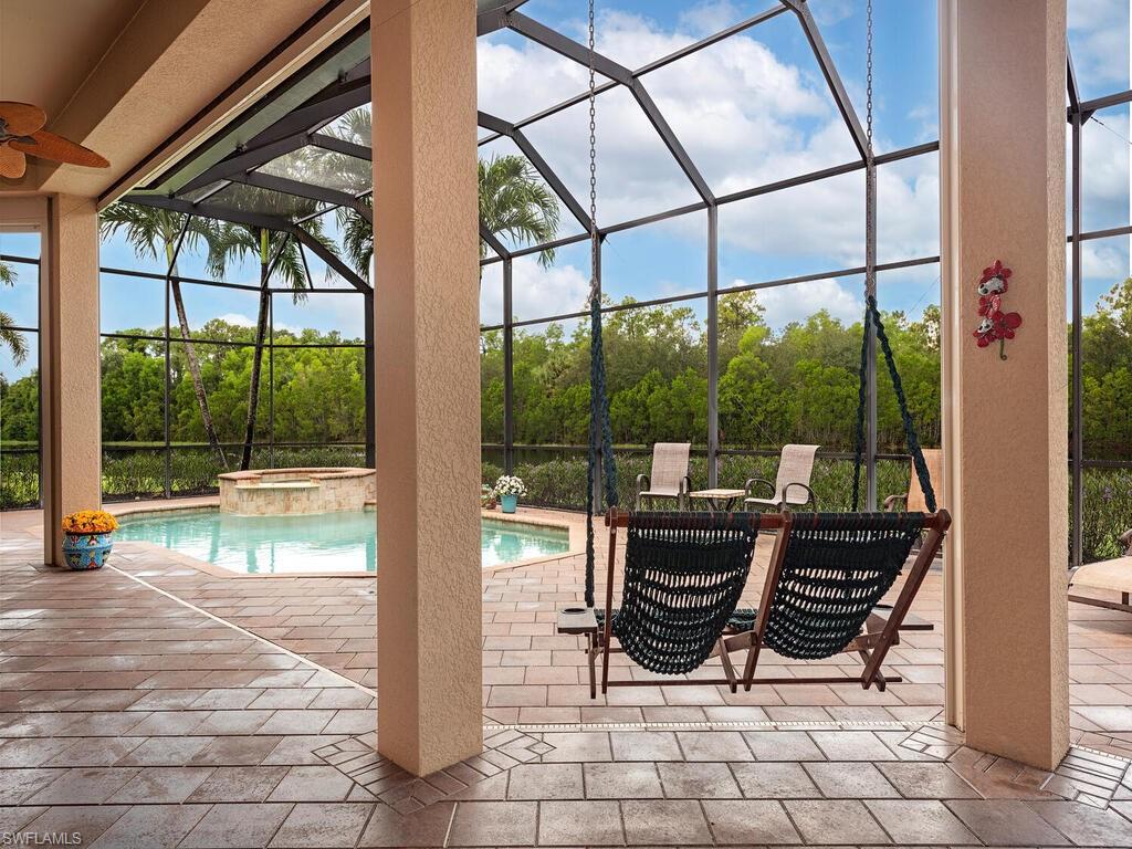 1749 Supreme Court Naples, FL 34110 - Photo 15 of 18 a view of a chairs and table in the patio with a fire pit