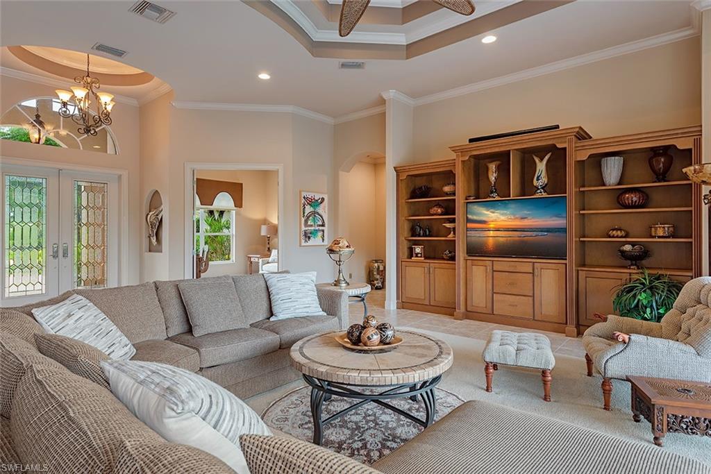 1749 Supreme Court Naples, FL 34110 - Photo 3 of 18 a living room with furniture and a dining table with kitchen view