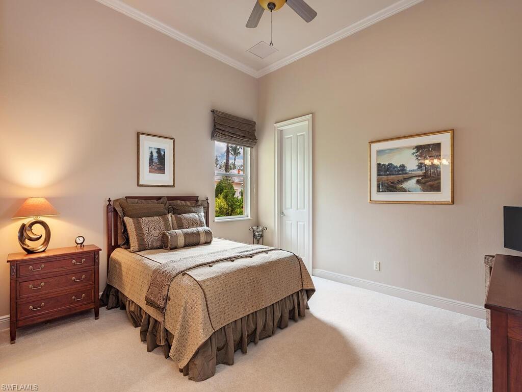 1749 Supreme Court Naples, FL 34110 - Photo 9 of 18 a bedroom with a bed a wall painting and a lamp