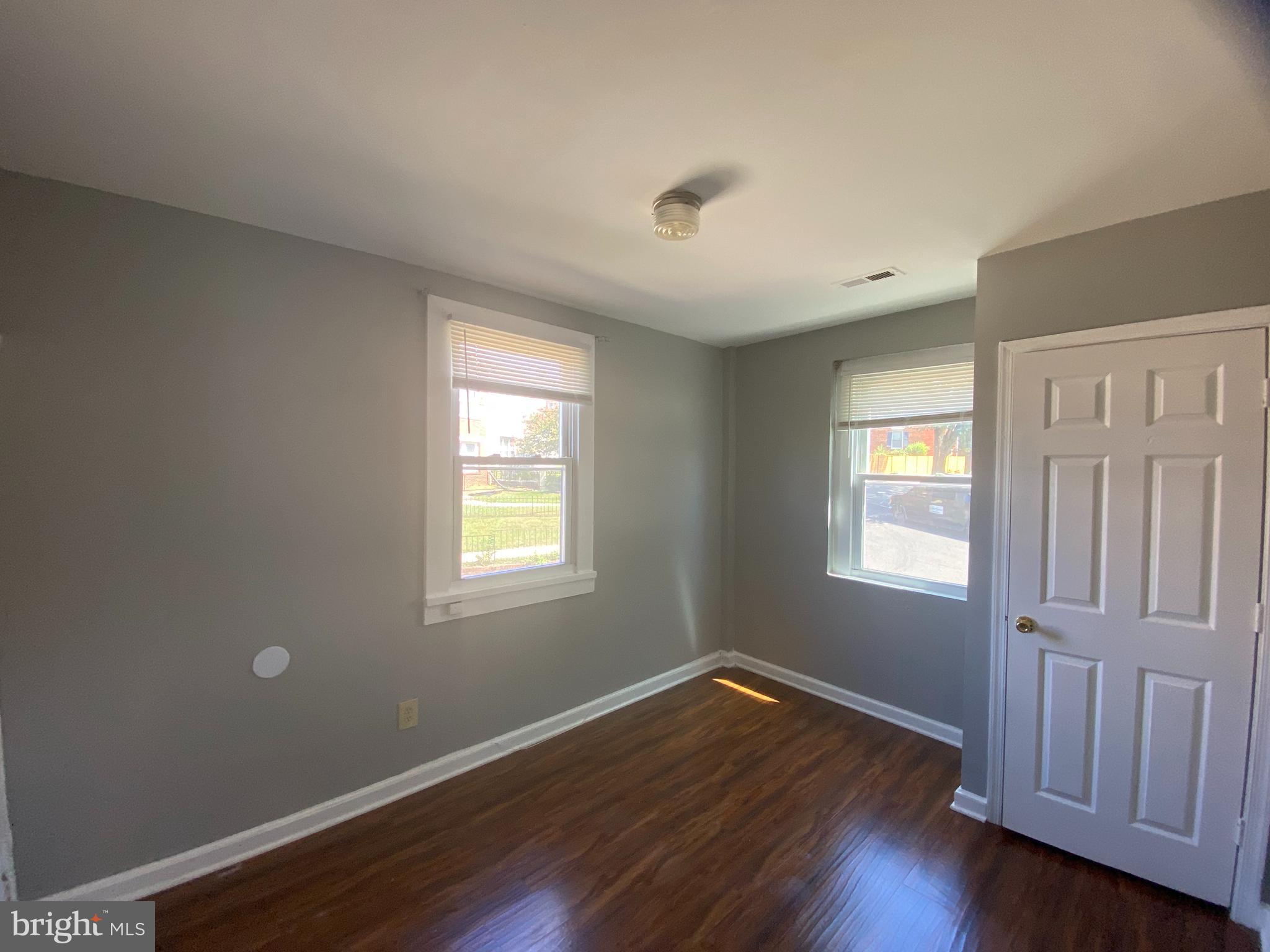 1324 Adams Street Northeast Washington, DC 20018 - Photo 18 of 22 a view of an empty room with wooden floor and window