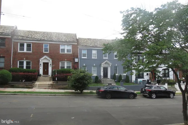 a car parked in front of a brick house