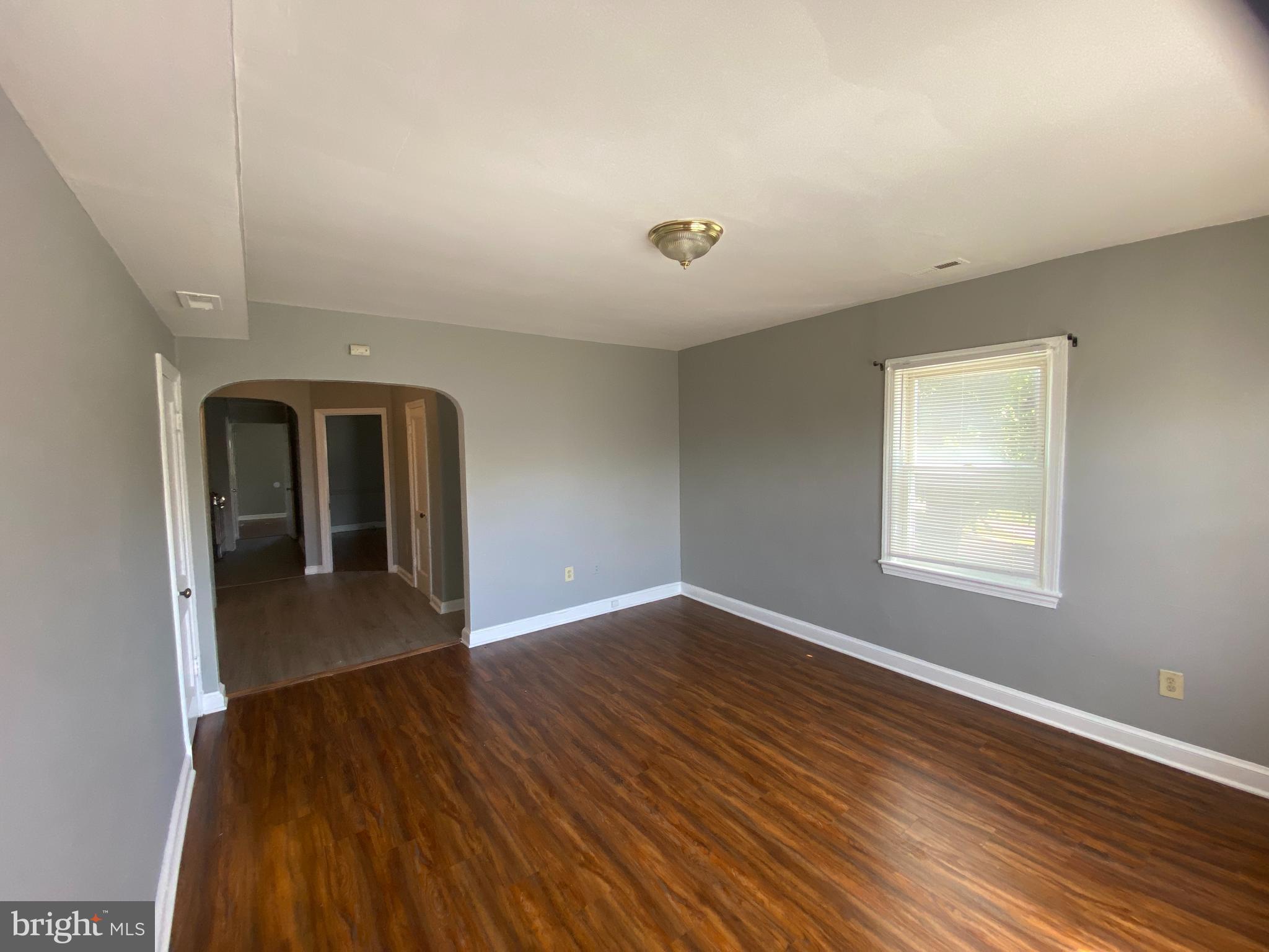 1324 Adams Street Northeast Washington, DC 20018 - Photo 4 of 22 a view of livingroom with hardwood floor and window