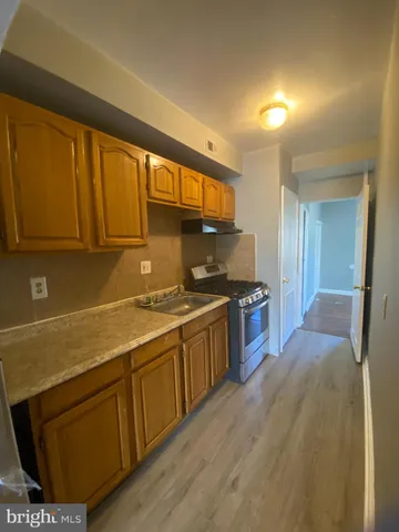 a kitchen with stainless steel appliances granite countertop a sink stove and cabinets
