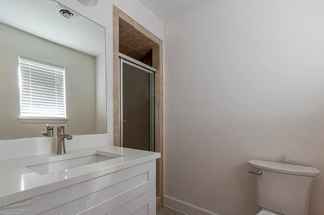 a bathroom with a sink a toilet and vanity