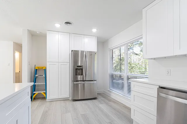a kitchen with stainless steel appliances a refrigerator and a sink
