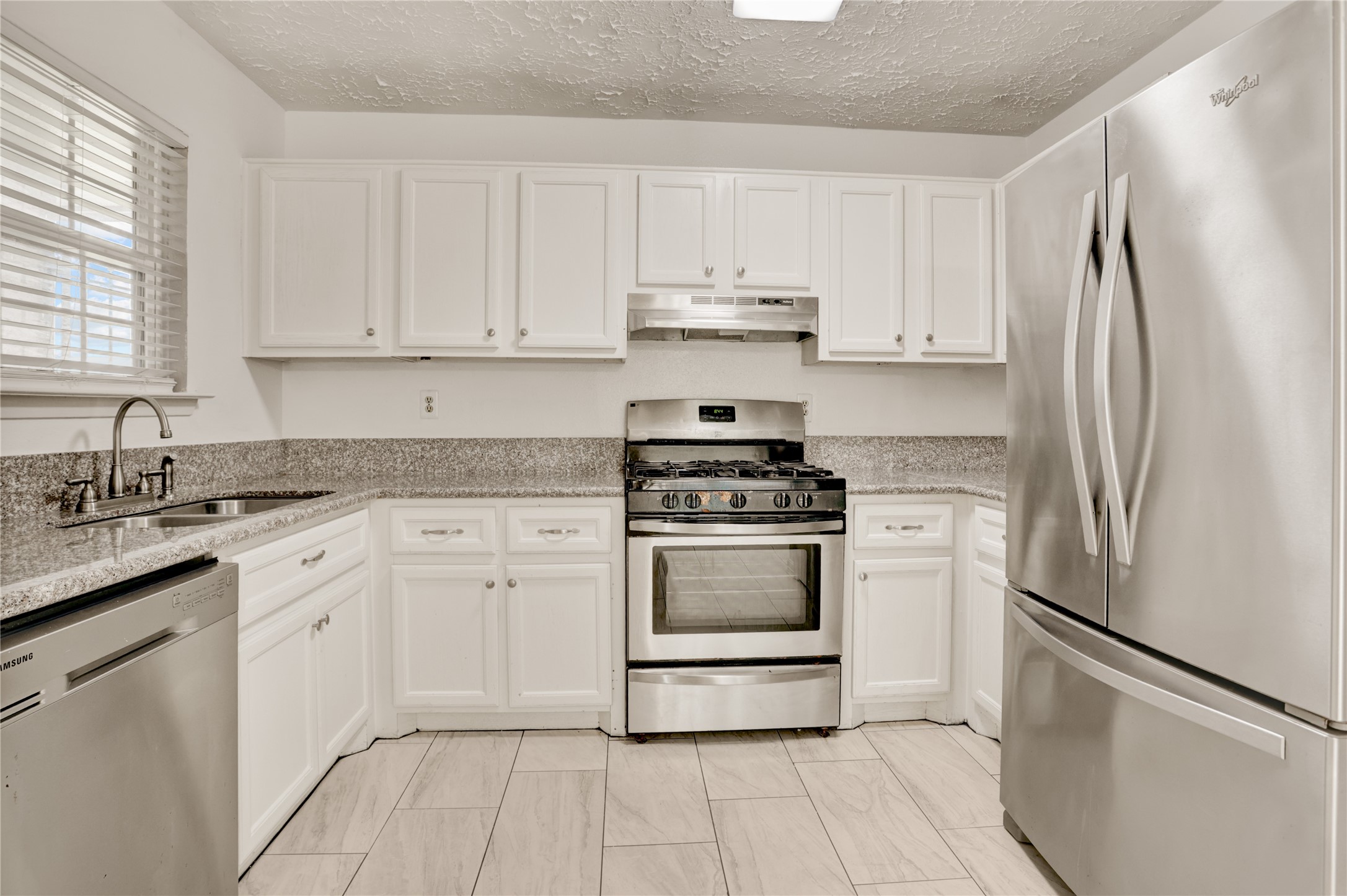 5437 Ridge Wind Lane Houston, TX 77053 - Photo 2 of 11 Updated kitchen featuring stainless steel appliances.