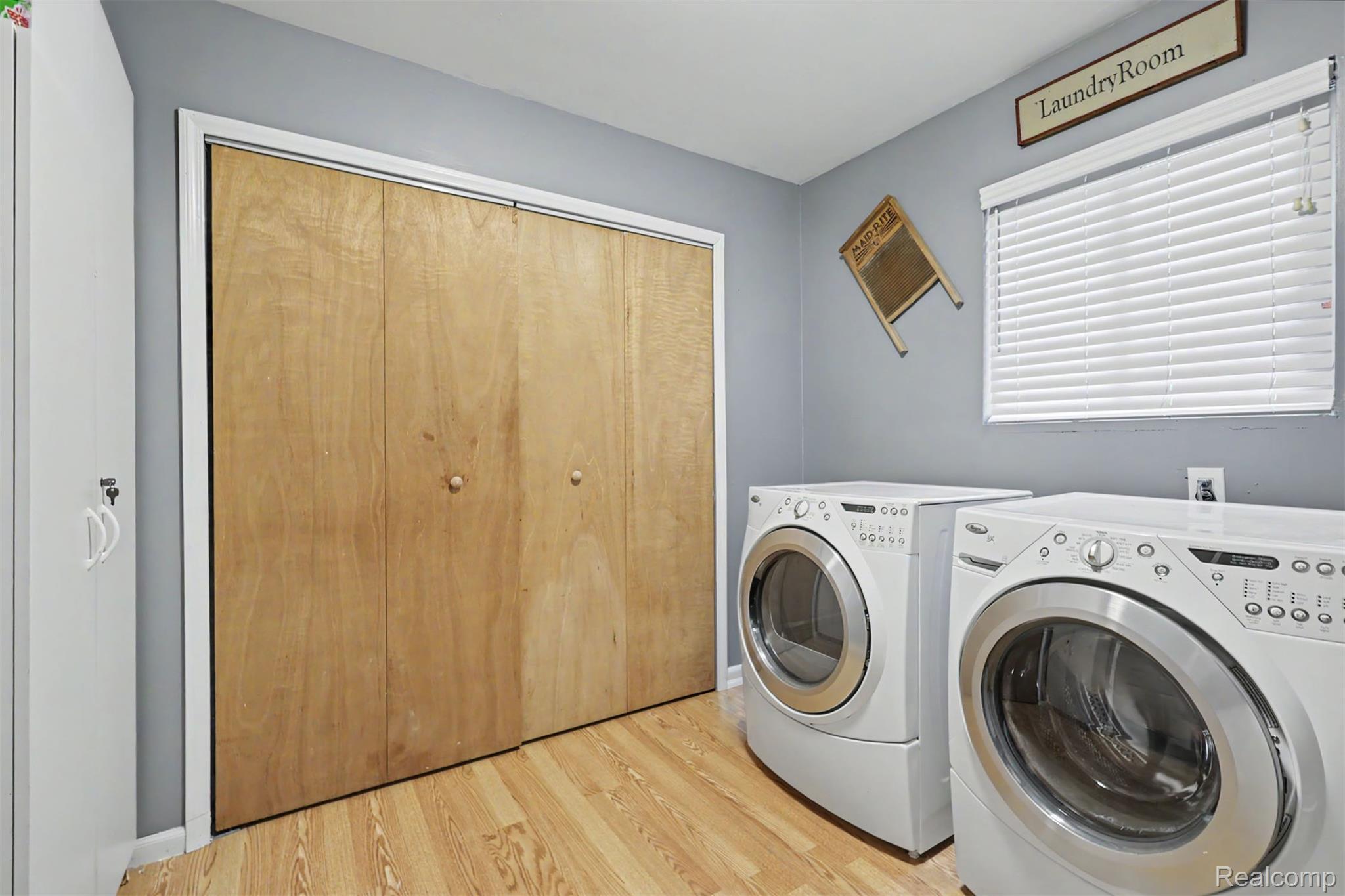 45223 Wear Road Belleville, MI 48111 - Photo 37 of 60 Laundry area featuring wood-finish flooring and integrated storage