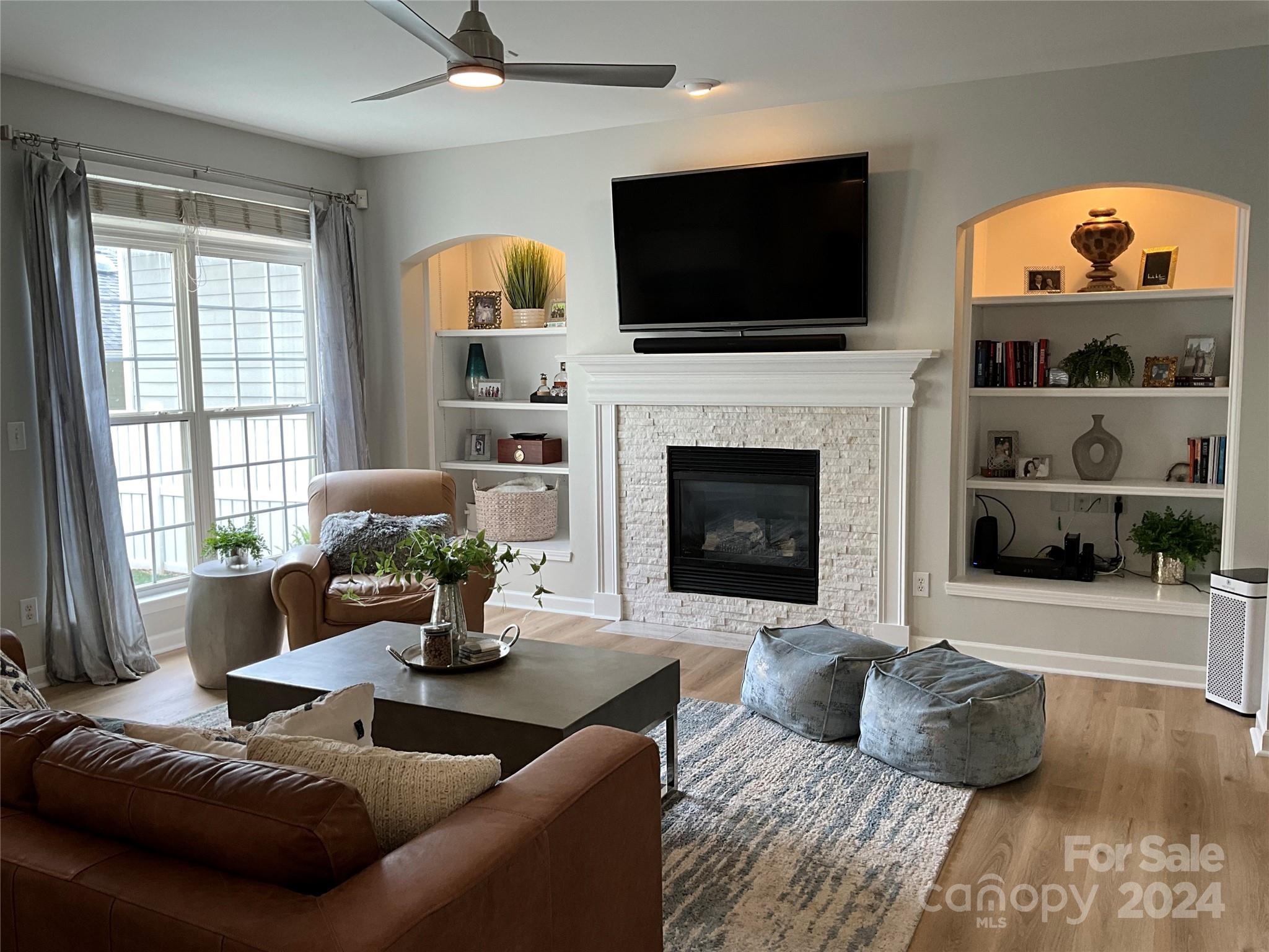 8126 Evanston Falls Road Huntersville, NC 28078 - Photo 13 of 42 a living room with furniture fireplace and flat screen tv
