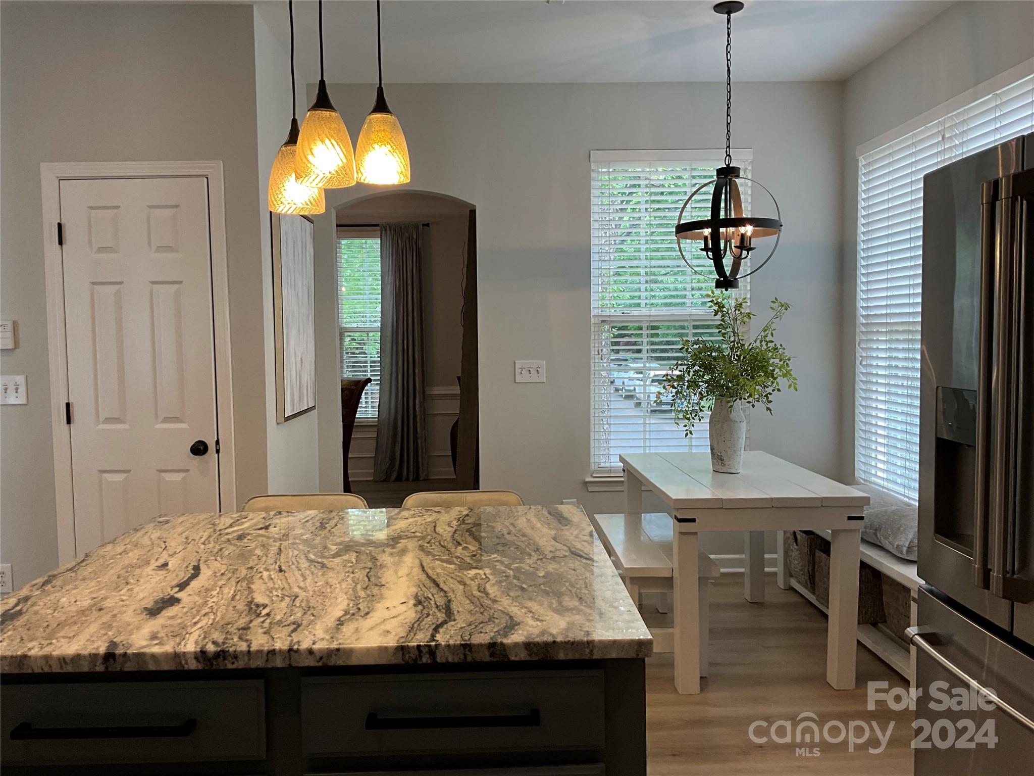8126 Evanston Falls Road Huntersville, NC 28078 - Photo 18 of 42 a bedroom with a bed and a chandelier