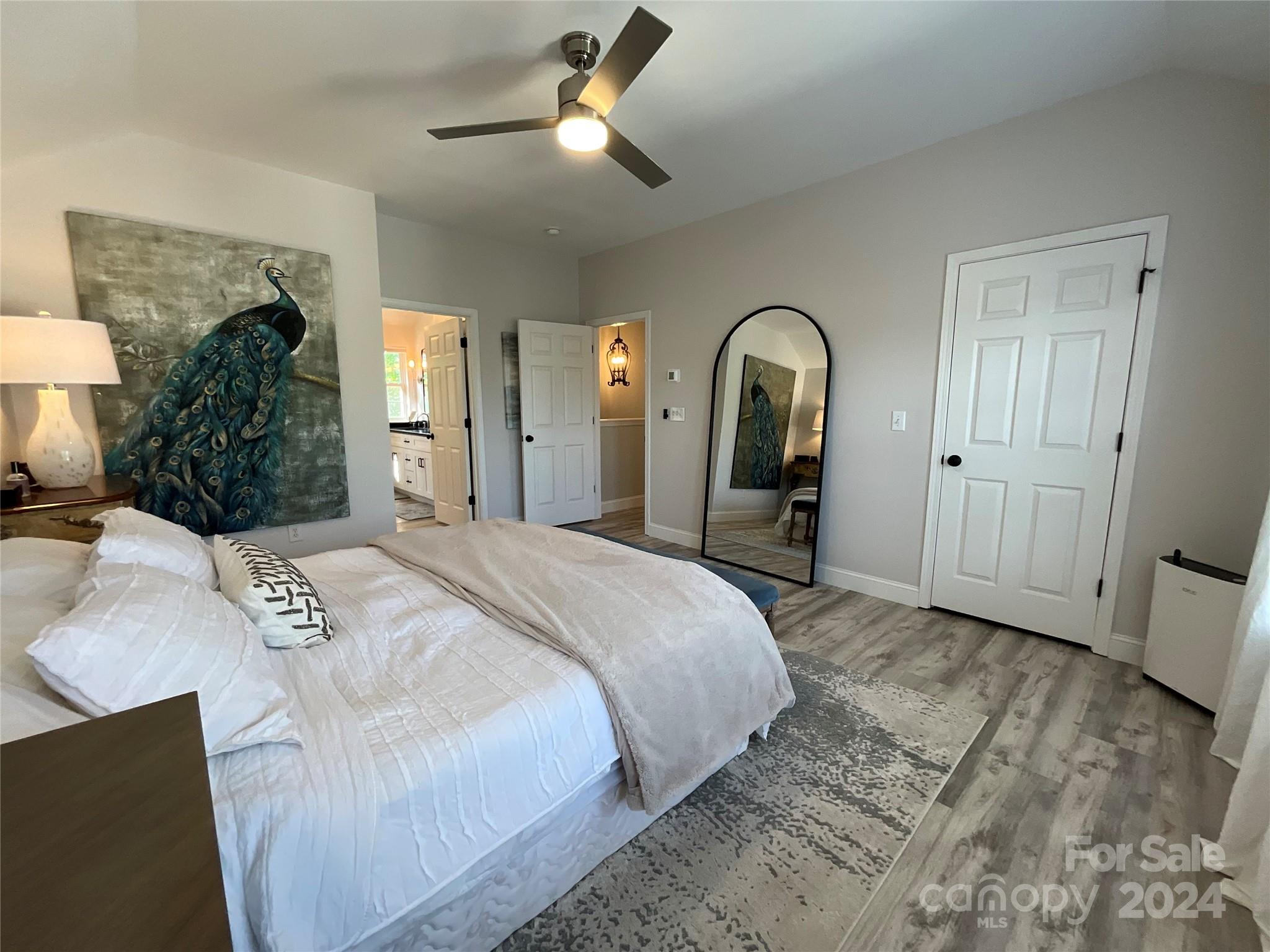 8126 Evanston Falls Road Huntersville, NC 28078 - Photo 22 of 42 a bedroom with a bed and a large mirror