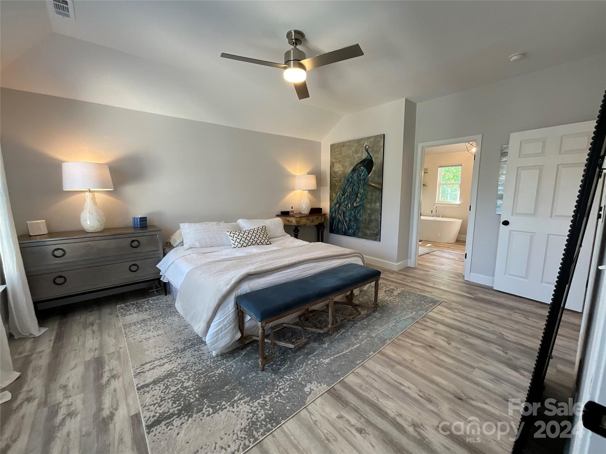 8126 Evanston Falls Road Huntersville, NC 28078 - Photo 23 of 42 a bedroom with a bed and a chandelier