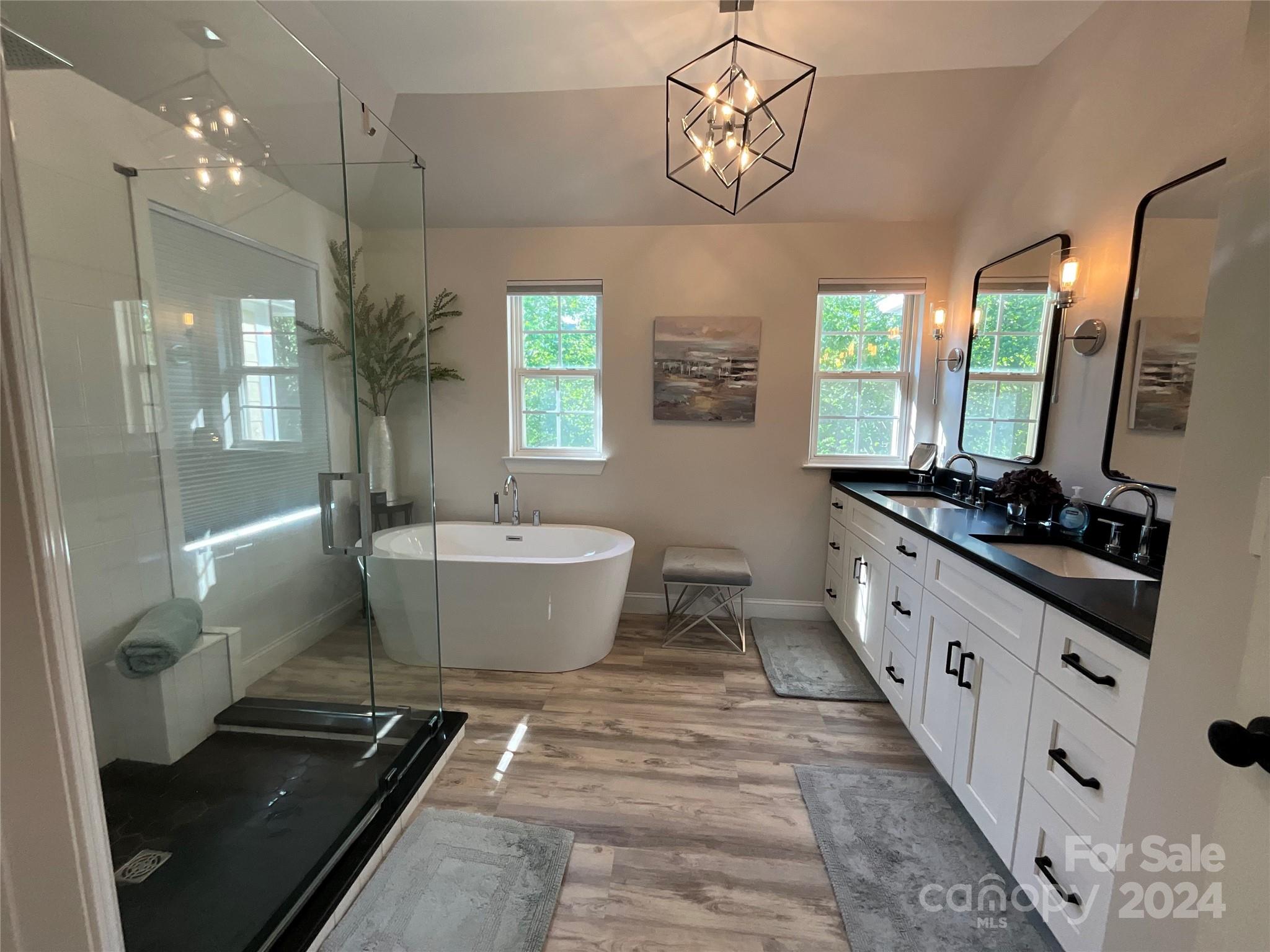 8126 Evanston Falls Road Huntersville, NC 28078 - Photo 24 of 42 a spacious bathroom with a large tub sink and mirror