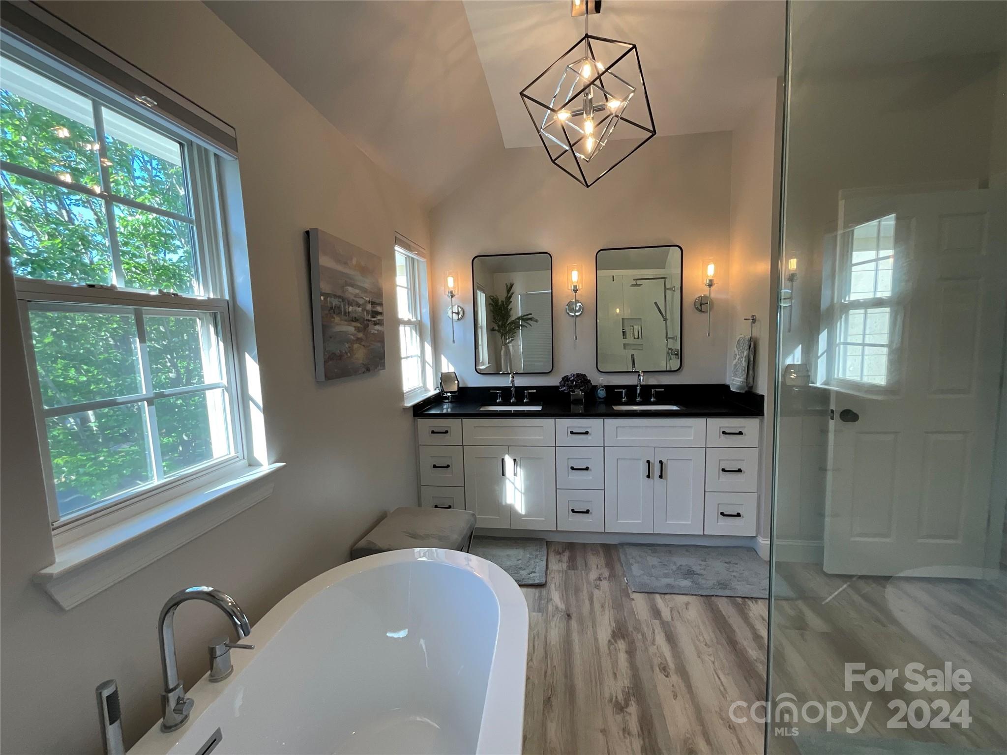 8126 Evanston Falls Road Huntersville, NC 28078 - Photo 27 of 42 a spacious bathroom with a granite countertop sink a mirror and window