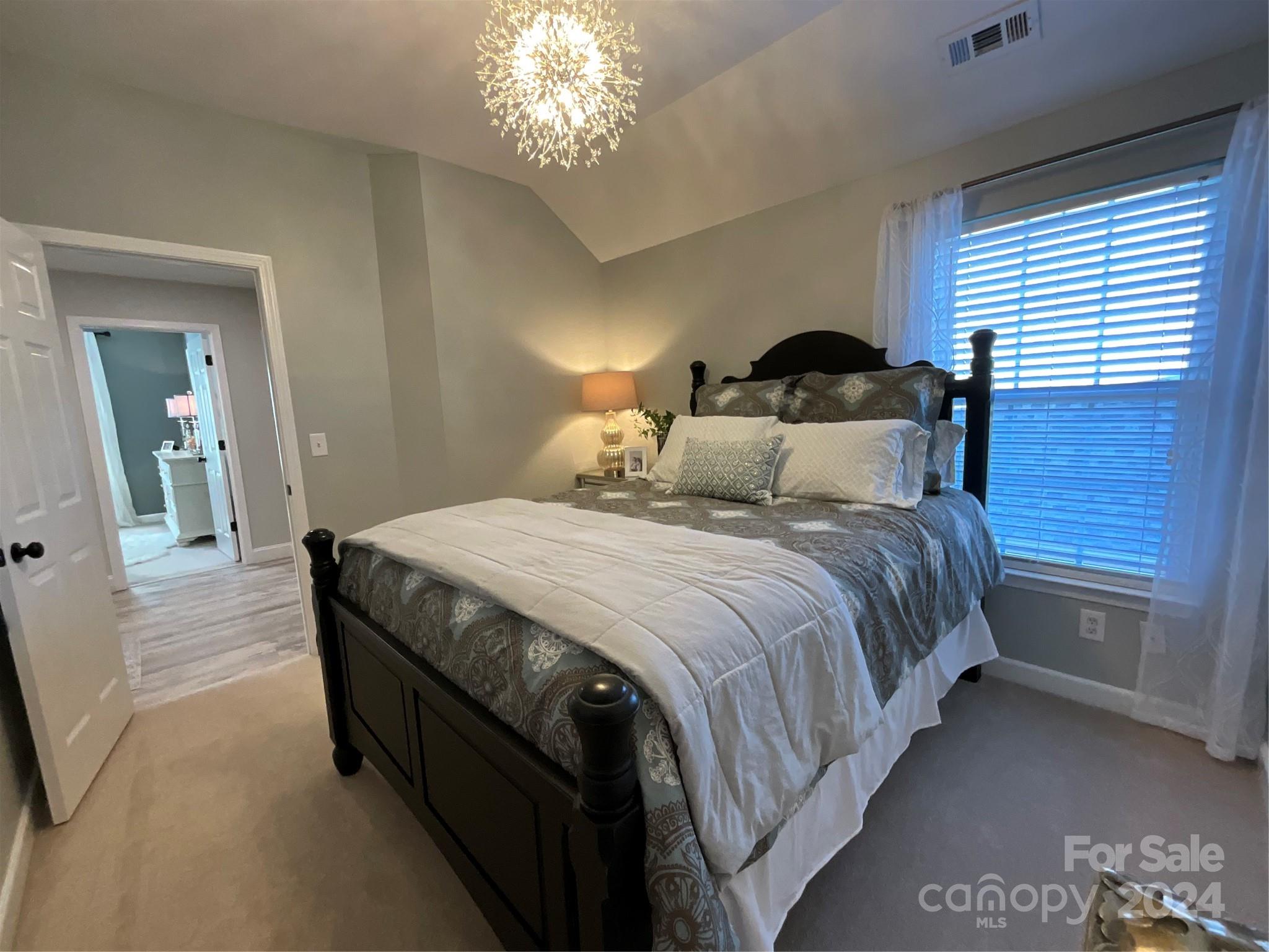 8126 Evanston Falls Road Huntersville, NC 28078 - Photo 31 of 42 a bedroom with a bed and a lamp on dresser
