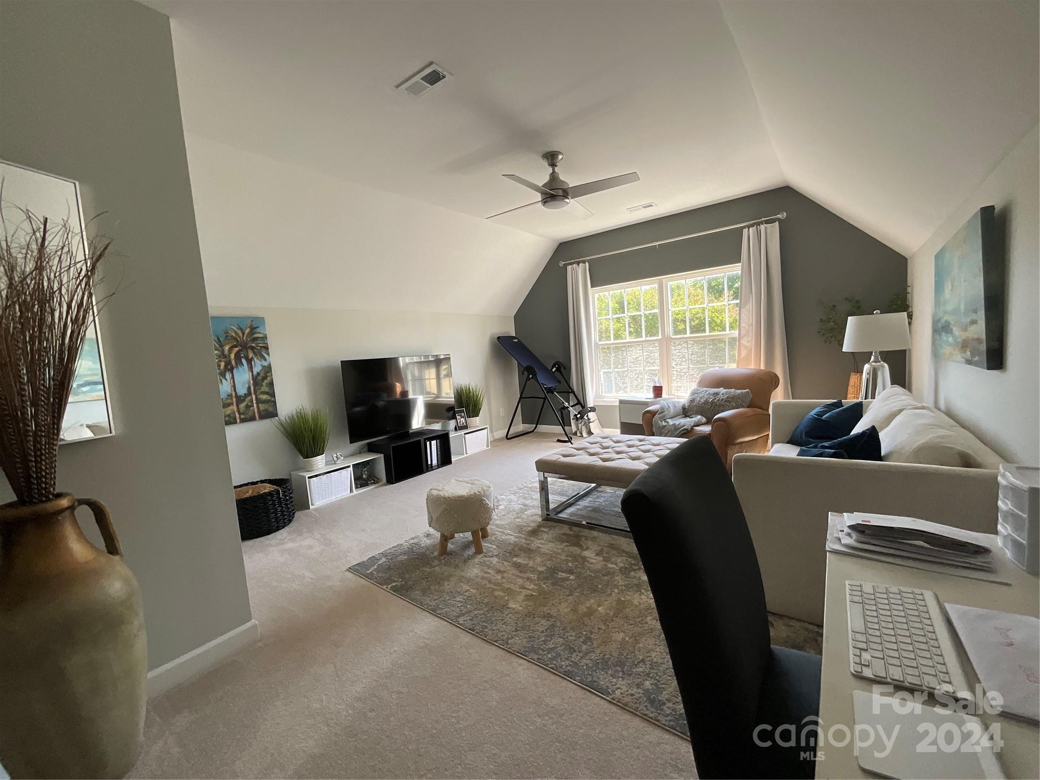 8126 Evanston Falls Road Huntersville, NC 28078 - Photo 33 of 42 a living room with furniture and a flat screen tv