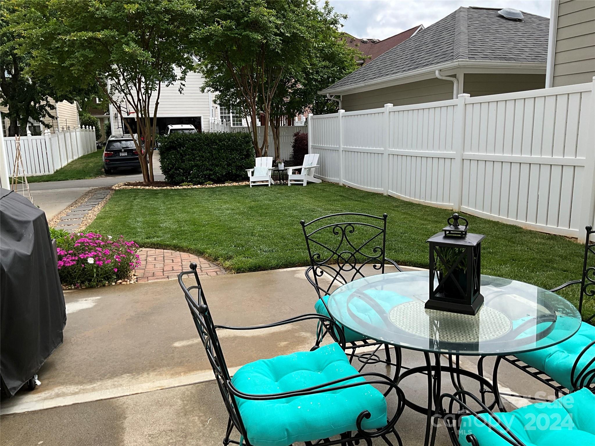 8126 Evanston Falls Road Huntersville, NC 28078 - Photo 36 of 42 a table and chairs in the garden