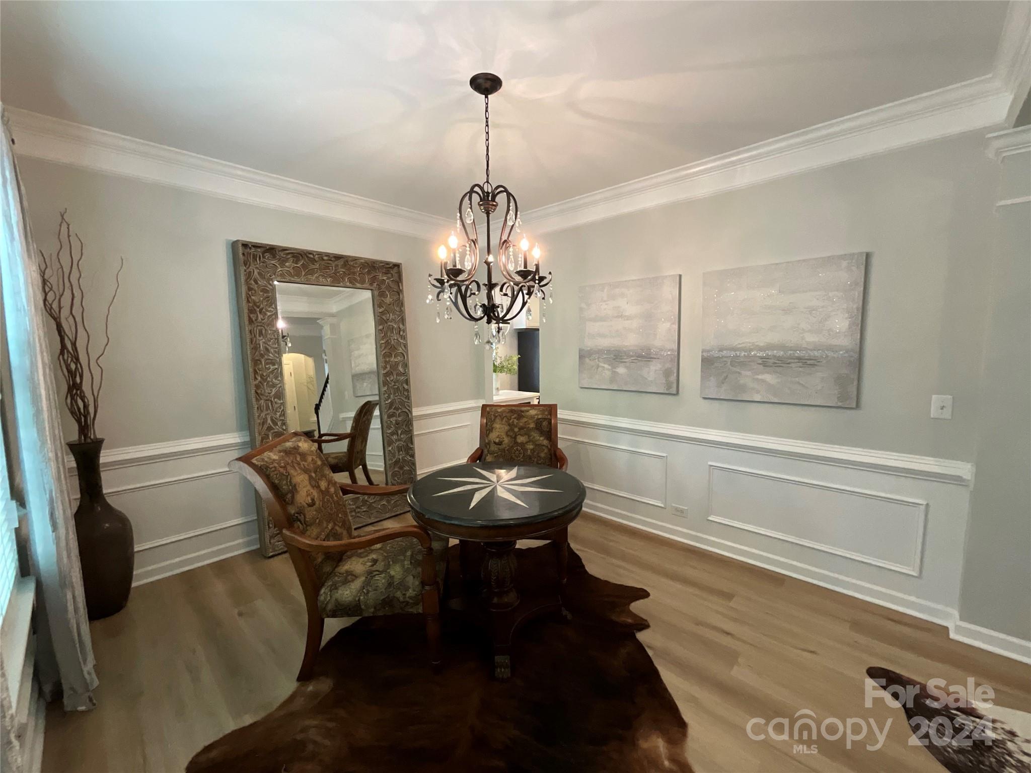 8126 Evanston Falls Road Huntersville, NC 28078 - Photo 8 of 42 a living room with furniture and a chandelier
