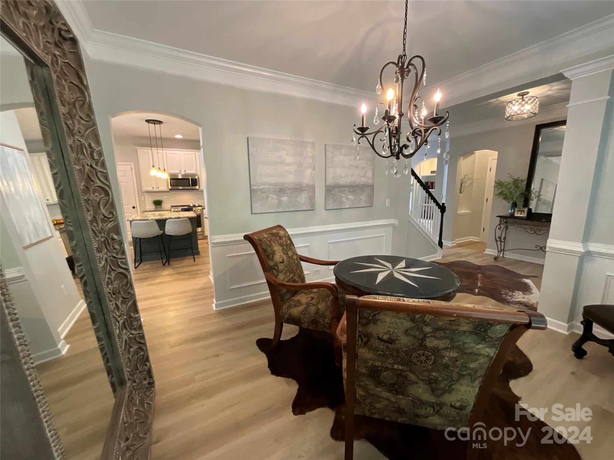 8126 Evanston Falls Road Huntersville, NC 28078 - Photo 9 of 42 a living room with furniture and a chandelier