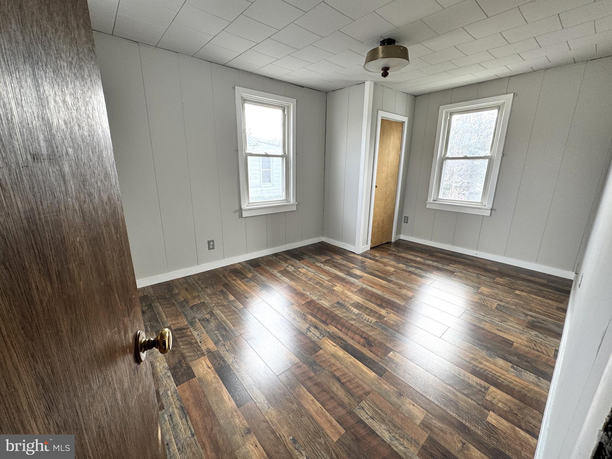 12 Maclay Street Milroy, PA 17063 - Photo 16 of 25 an empty room with wooden floor and windows