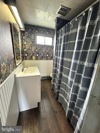 a room with water heater and a wooden floor