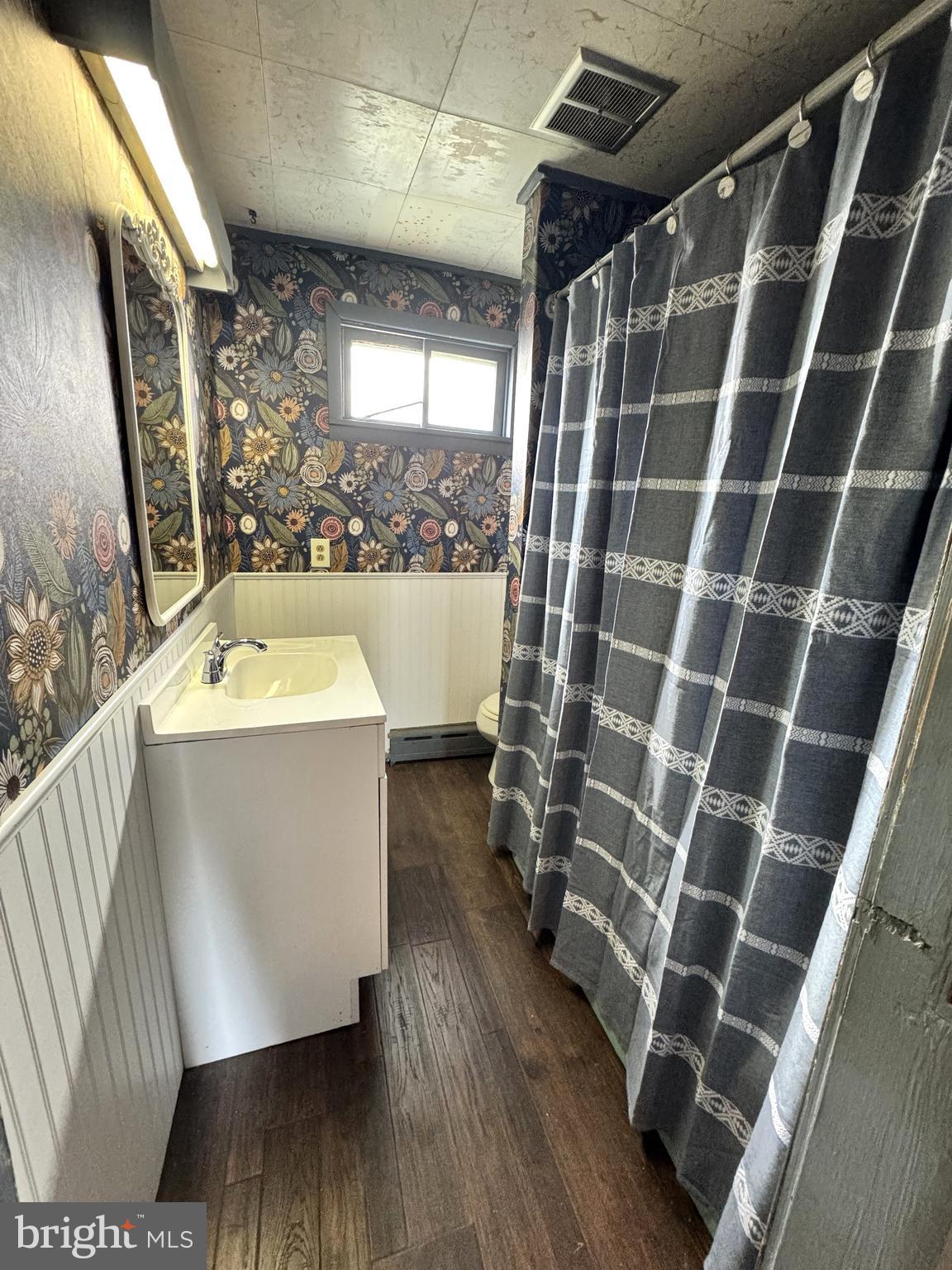 12 Maclay Street Milroy, PA 17063 - Photo 18 of 25 a room with water heater and a wooden floor