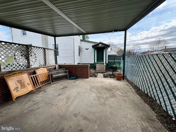 a view of a house with a big yard plants and large trees