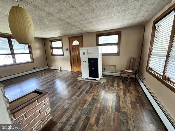 a view of a livingroom with wooden floor and a window