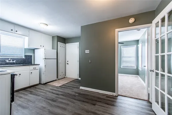 a kitchen with refrigerator and window