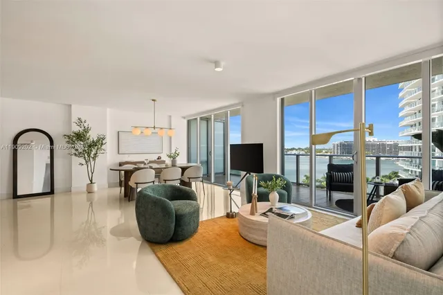 a living room with furniture a flat screen tv and a large window