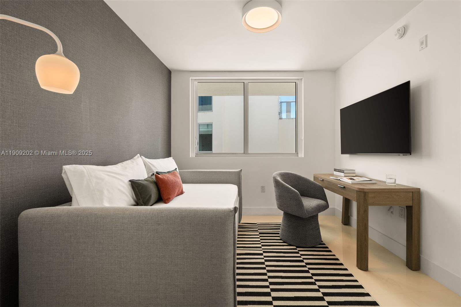 6620 Indian Creek Drive, Unit 713 Miami Beach, FL 33141 - Photo 23 of 39 a living room with furniture and a flat screen tv