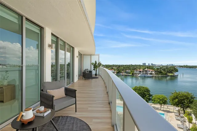 a view of a balcony with couch and wooden floor