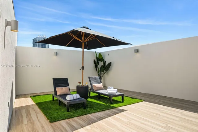 a view of a patio with furniture and a table