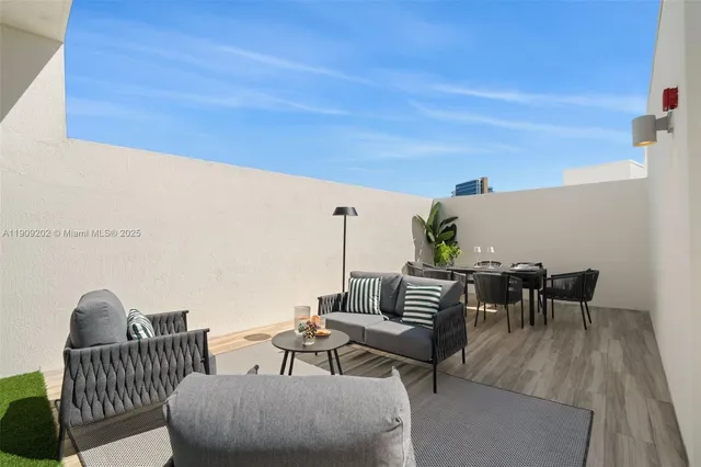 a view of a patio with a table and chairs