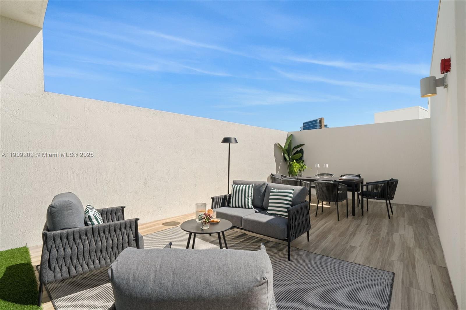 6620 Indian Creek Drive, Unit 713 Miami Beach, FL 33141 - Photo 29 of 39 a view of a patio with a table and chairs