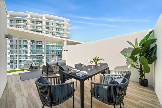 a balcony with table and chairs