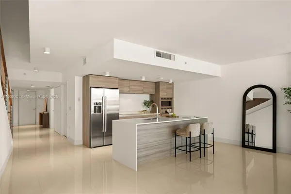 a kitchen with refrigerator and table