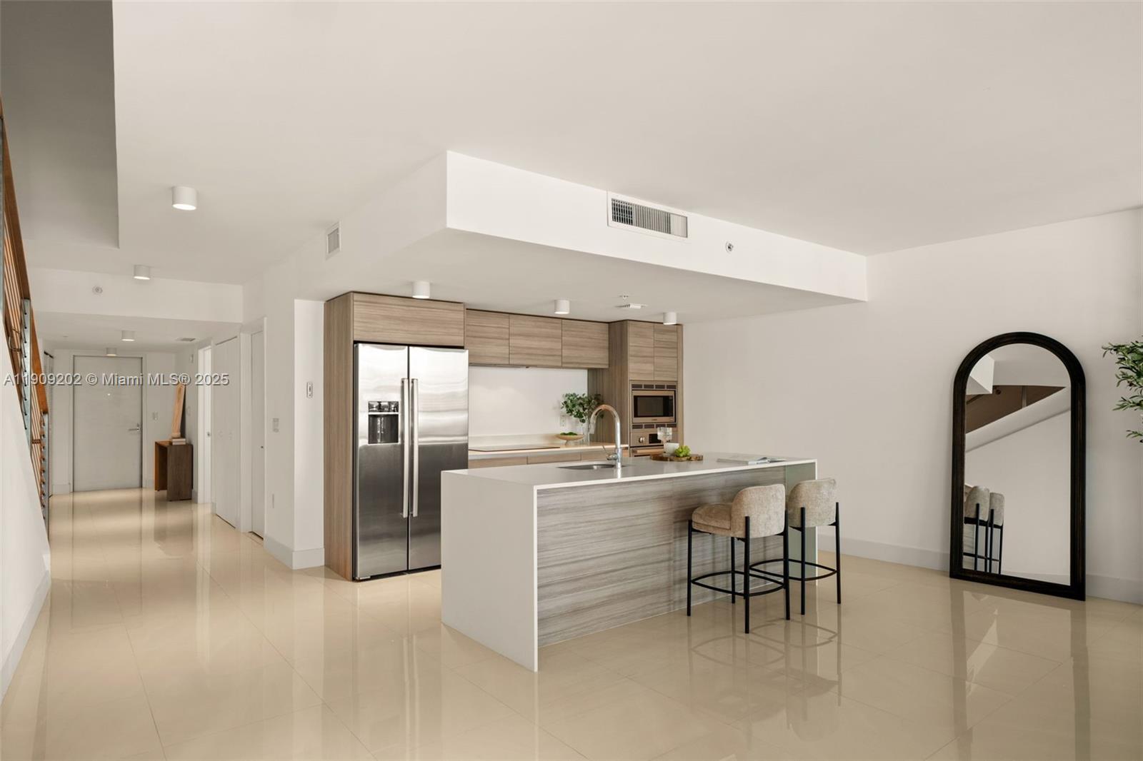 6620 Indian Creek Drive, Unit 713 Miami Beach, FL 33141 - Photo 6 of 39 a kitchen with refrigerator and table